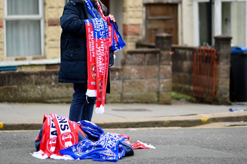 A scarf seller selling half and half scarfs