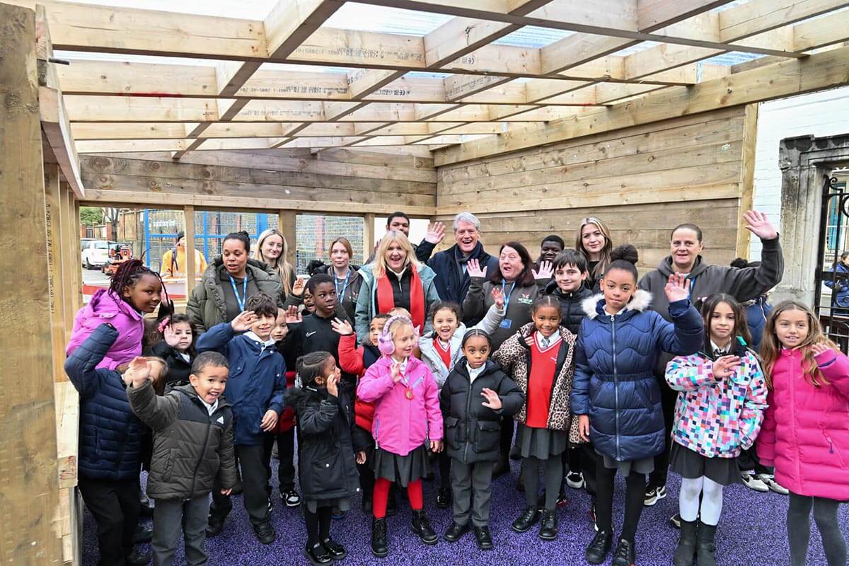 Cllr Coleman (centre right) and manager Julie Cavanagh (centre left) with local children at Sands End Adventure Playground, Fulham