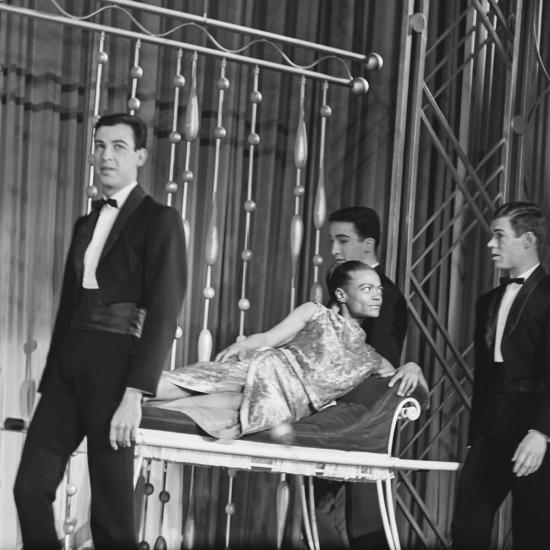 Eartha Kitt carried onto the stage on a chaise longue by men during rehearsals for the Royal Variety Performance at the Palladium Theatre in London, 29 October 1962. Credit: Getty Images