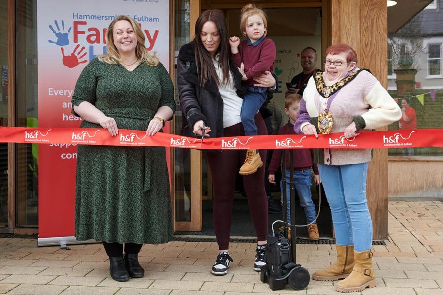 Cllr Alex Sanderson (left) and Cllr Patricia Quigley (right) help a visitor cut the Family Hub opening ribbon at Fulham’s Stephen Wiltshire Centre
