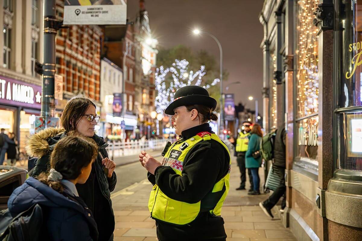 H&F Law Enforcement Officer (right) speaking to residents on King Street, Hammersmith