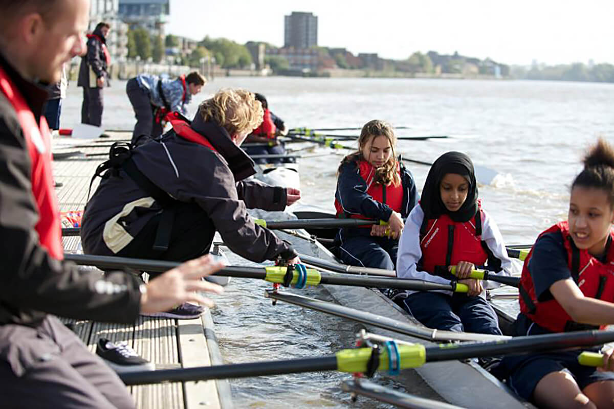 Young people  preparing to row on the Thames from Fulham Reach Boat Club