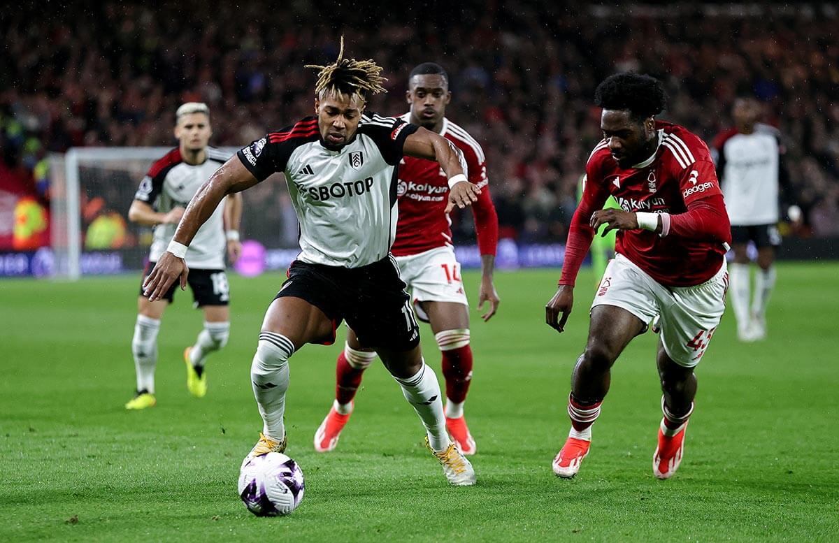 Fulham's Adama Traore is challenged by Nottingham Forest's Ola Aina (right) at the City Ground
