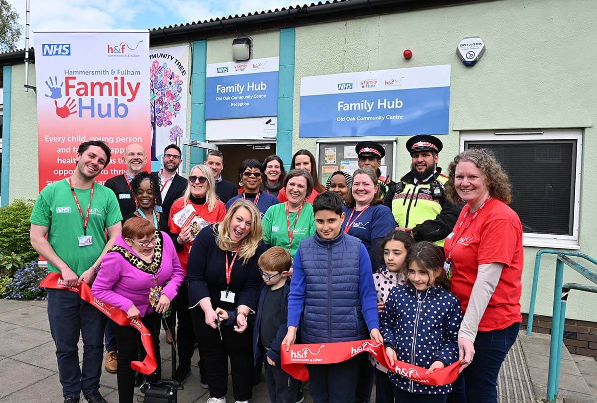 Cllr Sanderson (centre) and Cllr Quigley (second from left) cut the ribbon at Family Hub Old Oak Community Centre with residents and partners