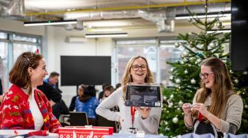 Cllr Apthorp packing donated Christmas gift with H&F officers.