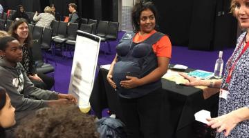 Young wearing a pregnancy belly