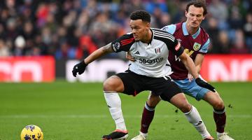 Rodrigo Muniz of Fulham (left) is challenged by Hjalmar Ekdal of Burnley at Turf Moor