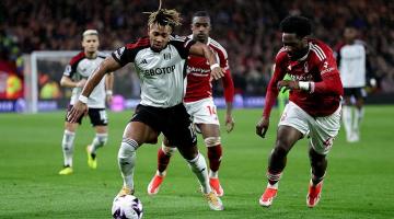 Fulham's Adama Traore is challenged by Nottingham Forest's Ola Aina (right) at the City Ground
