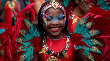 A young performer parades in costume on families and children's day at Notting Hill Carnival 2023