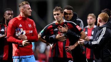 Timothy Castagne is comforted by teammate Rodrigo Muniz after missing during the penalty shoot-out 