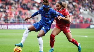 Kadeisha Buchanan battles for possession with Olivia Smith