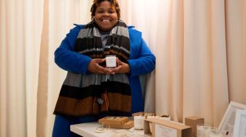 Nicole, founder of Shades of Blackness, poses with her products