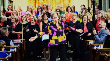 Music by the Bridge curator, Anna Boucher, (middle) with choir at All Saints Fulham