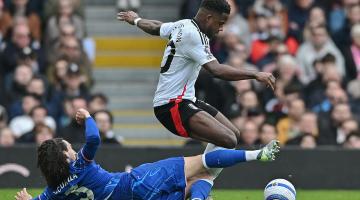 Fulham's Ryan Sessegnon (standing) is tackled by Chelsea's Marc Cucurella