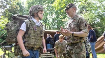 H&F Youth Mayor Albi Fenner tries on army uniform at H&F's D-Day celebrations 2024