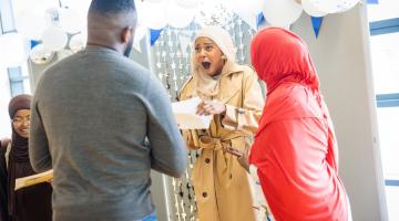 Excited student opening GCSE results at Phoenix Academy