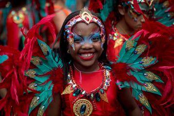 A young performer parades in costume on families and children's day at Notting Hill Carnival 2023