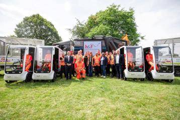 Cllr Holder (centre right) with H&F's waste team and their electric fleet