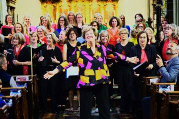 Music by the Bridge curator, Anna Boucher, (middle) with choir at All Saints Fulham