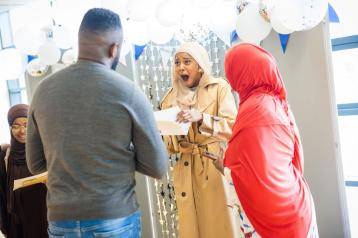Excited student opening GCSE results at Phoenix Academy