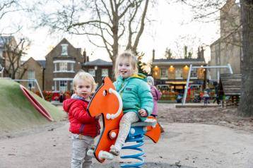 Children playing in Brook Green's playground