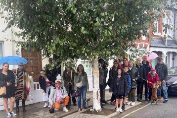 Fred Thompson's neighbours alongside the silver birch tree he previously persuaded H&F Council to plant