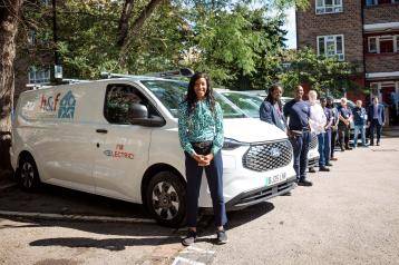 Cllr Frances Umeh with the housing repairs team and their new fleet of electric vans