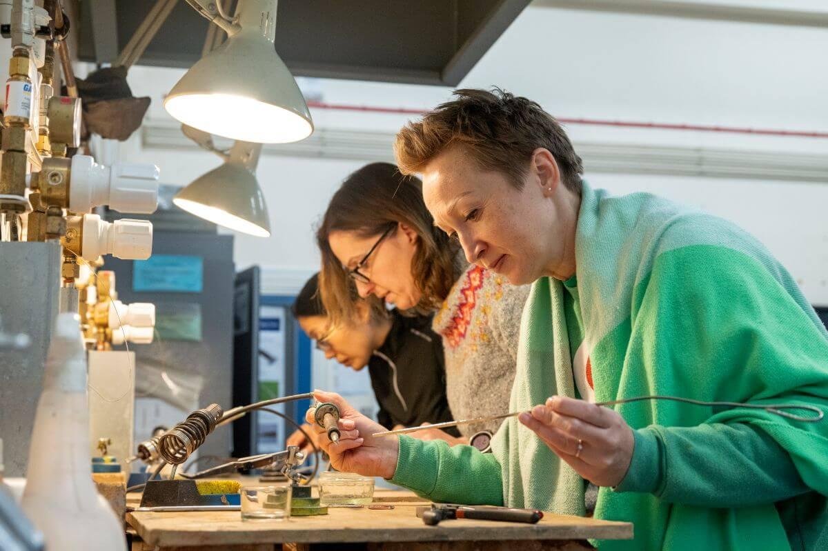Macbeth Centre students soldering stained glass