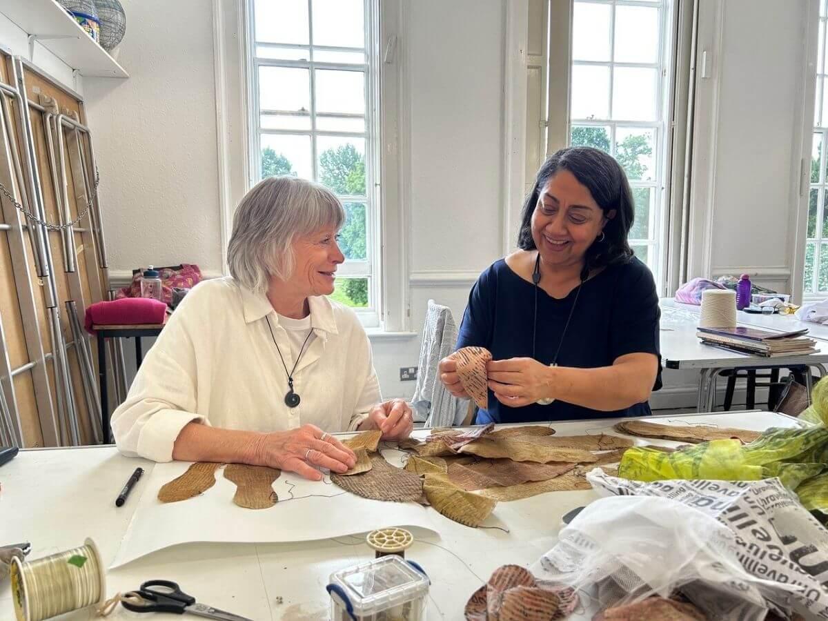 Amarjeet Nandhra (right) teaching a hand stitching class