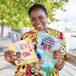 A woman holding two children's books