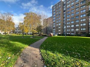 A block of flats with an open green space in front.