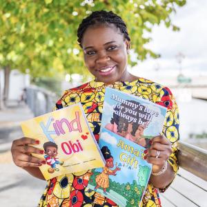 A woman holding two children's books