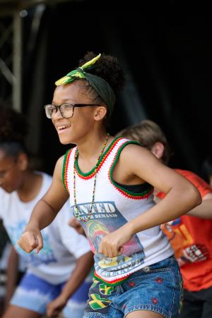 A girl dances at H&F's Windrush 75 celebrations in Shepherds Bush Green