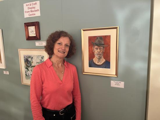 Artist Gill Haynes with her oil on canvas painting, The Jaunty Angle