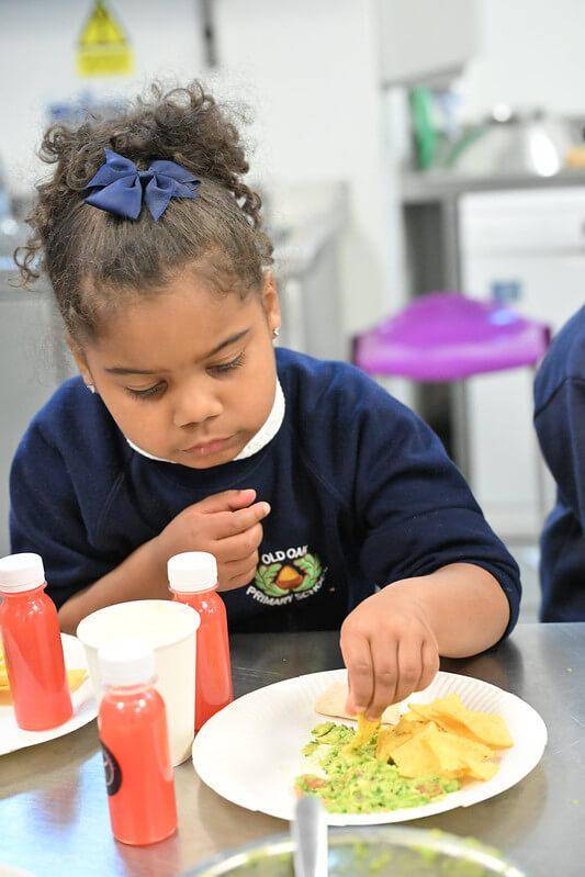 Little girl joins guacamole cooking class