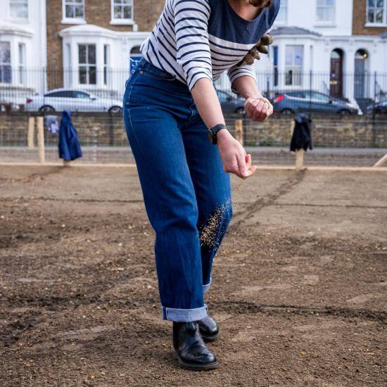 Volunteer sowing seeds in Eelbrook Common