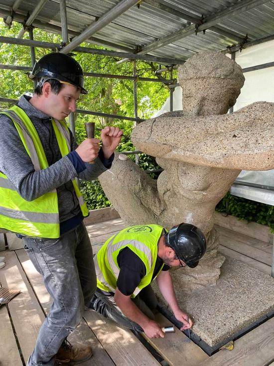 Leaning Woman conservators at work