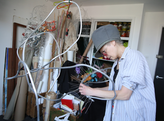 Person working on a metal sculpture