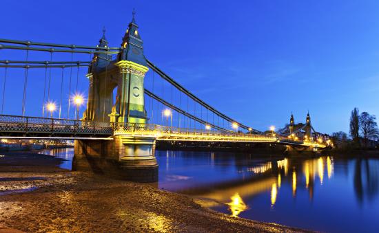 Hammersmith Bridge at dusk with electric lighting switched on