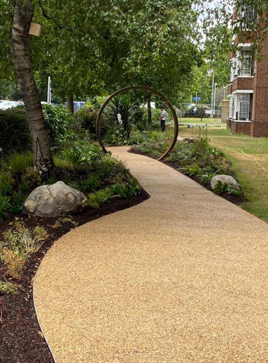Pathway and circular arch in the community garden at Aspen Gardens.