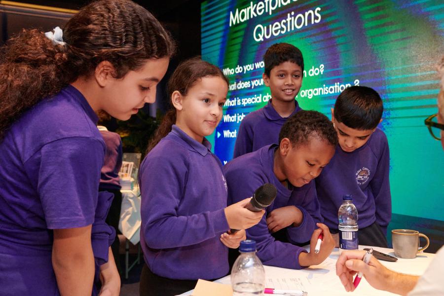 Primary school pupils from Miles Coverdale Primary School quizzing business leaders at H&F’s White City Reveal event