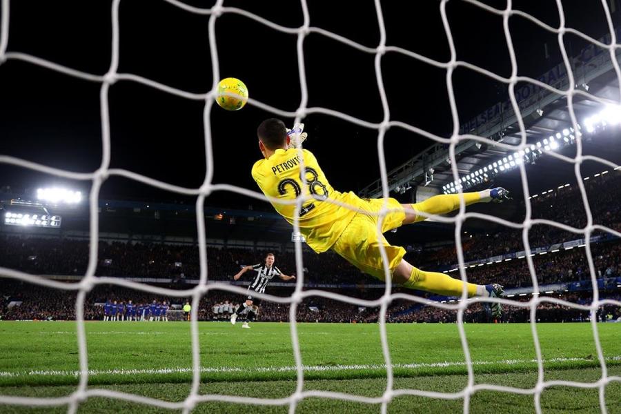 Blues keeper Djordje Petrovic makes a flying penalty save to deny Matt Ritchie of Newcastle