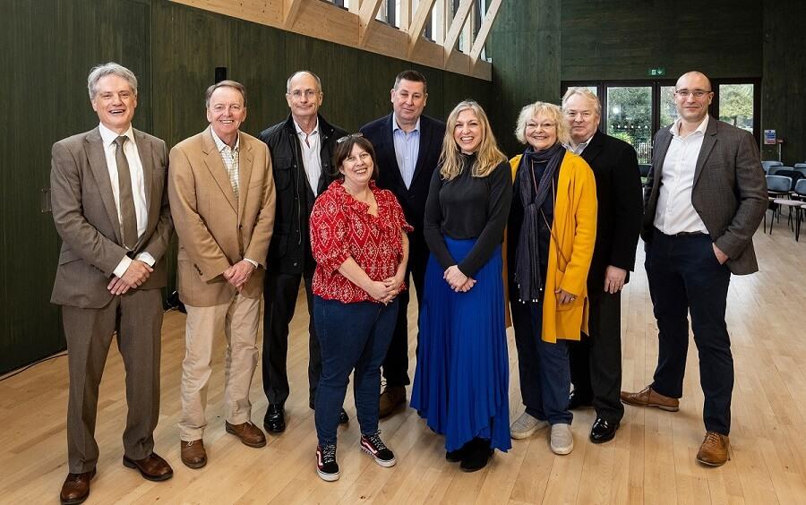 H&F Leader Cllr Stephen Cowan (centre back row) and Deputy Leader Cllr Ben Coleman (far left) open the community-run Sands End Arts & Community Centre in March 2022.