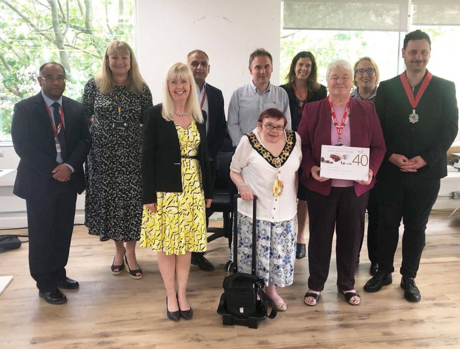 H&F Mayor Patricia Quigley and H&F Chief Executive Sharon Lea (centre) present a 40-year long service award to staff member Lorraine Mason. Pictured with them is the council’s Senior Leadership Team, as well as Cllr Florian Chevoppe-Verdier (far right).