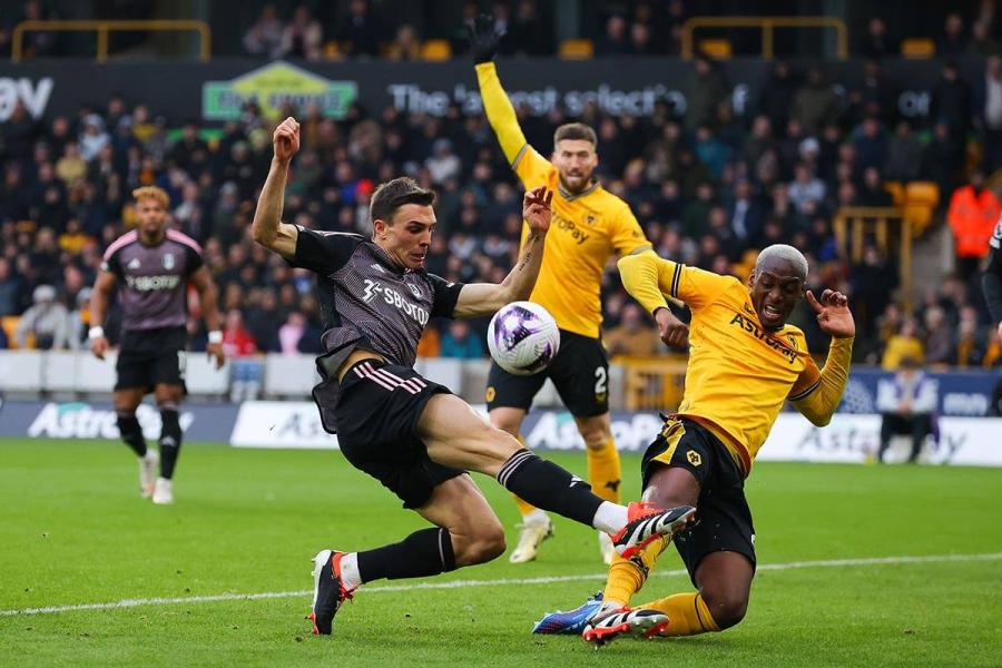 Fulham's Joao Palhinha (left) shoots under pressure from Toti Gomes of Wolves