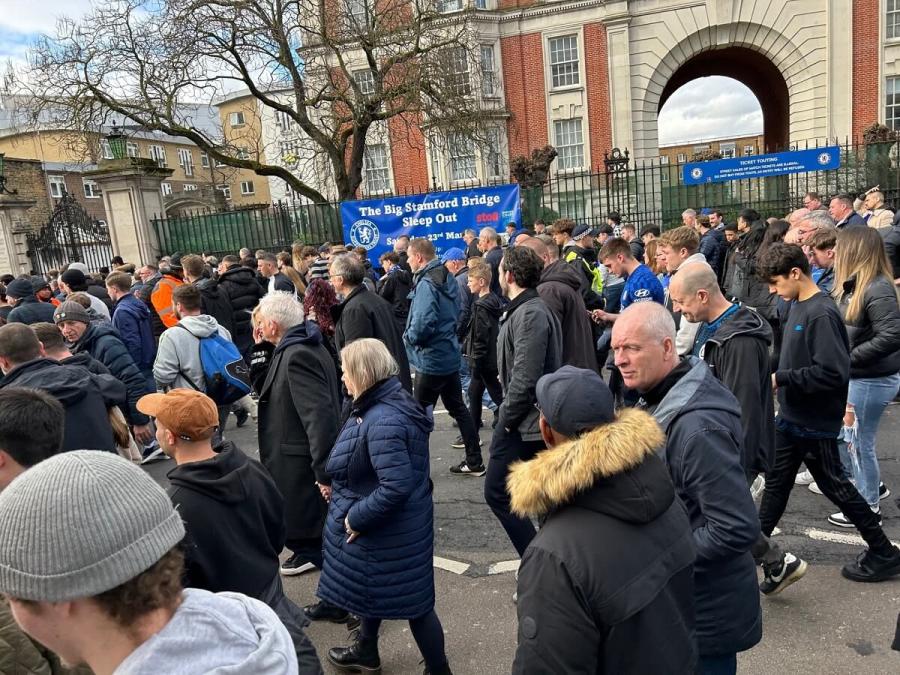 Fans leaving Stamford Bridge, walking past the Stroll building.
