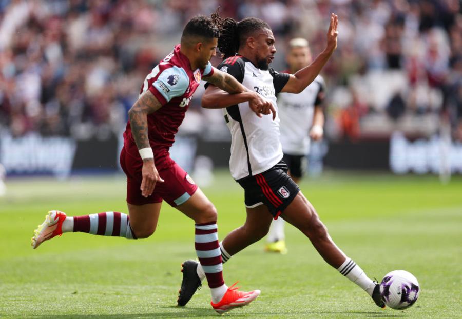 Alex Iwobi of Fulham (right) is challenged by West Ham's Emerson Palmieri