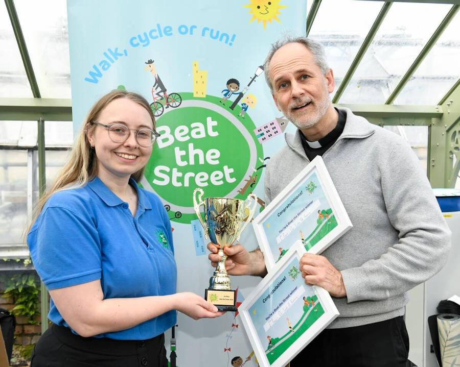 Father Richard Nesbitt (right) from Our Lady of Fatima Church, White City, collecting the community group's award