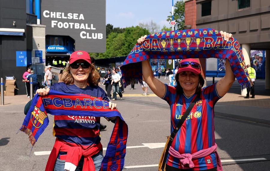 Barcelona fans pose for a photo outside the stadium