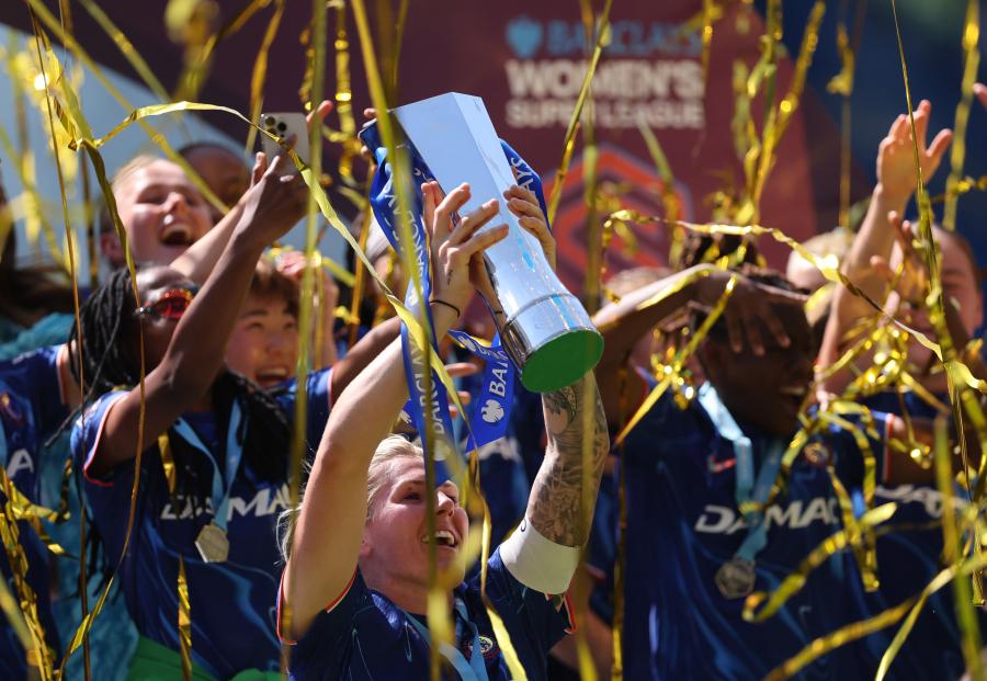 Millie Bright lifts the trophy
